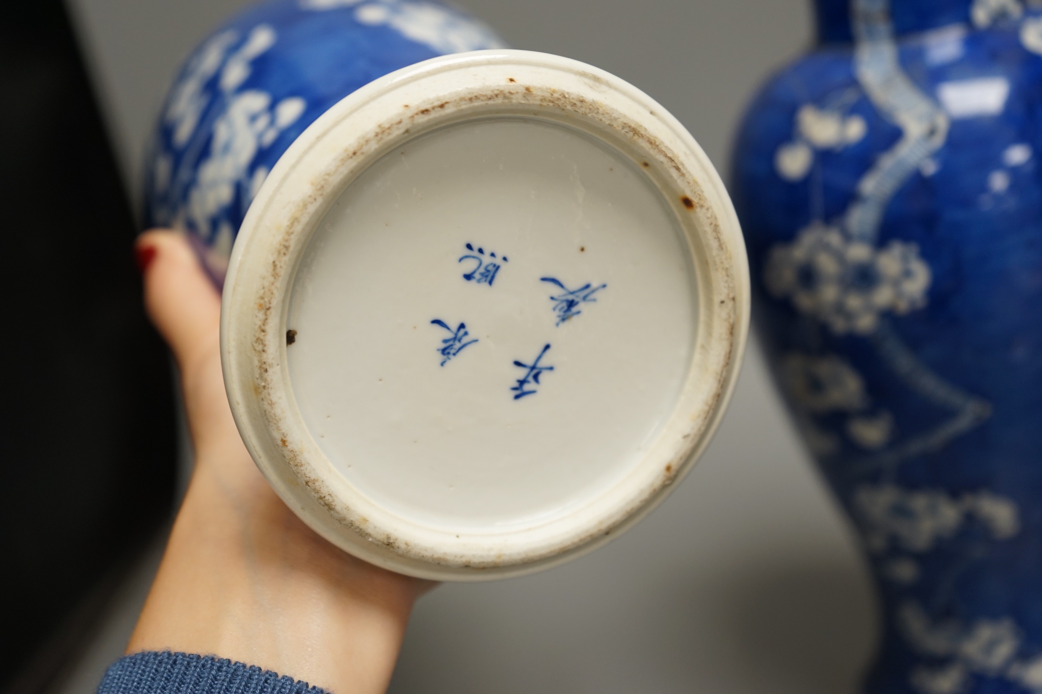 A pair of 19th century Chinese blue and white prunus vases, one a.f, 37cm